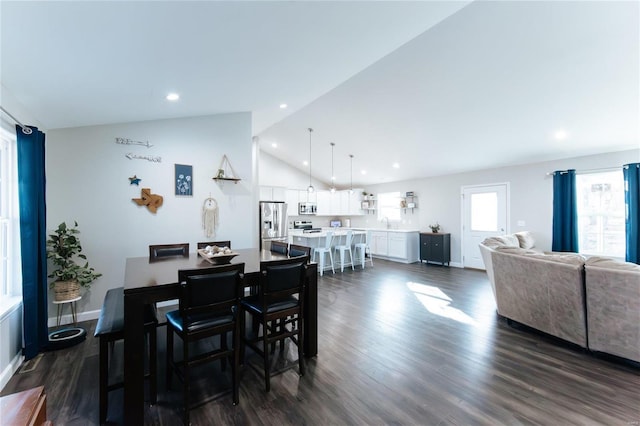 dining room featuring high vaulted ceiling, baseboards, dark wood finished floors, and recessed lighting