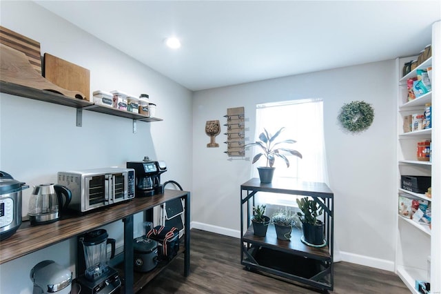 office area with baseboards and dark wood finished floors