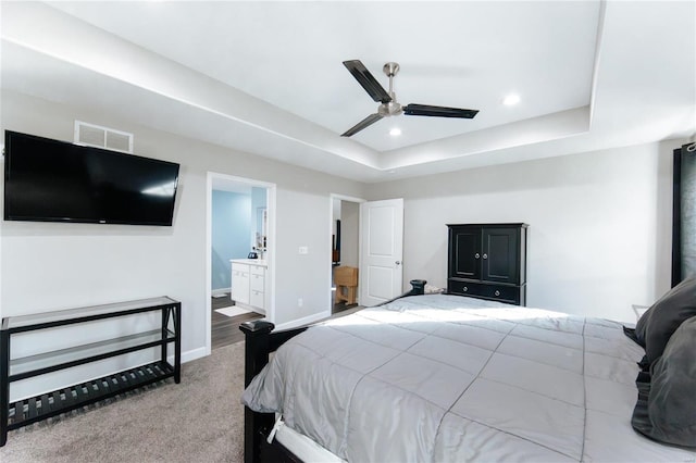 bedroom featuring carpet, visible vents, a tray ceiling, and recessed lighting