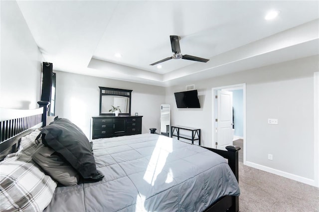 bedroom featuring a tray ceiling, recessed lighting, a ceiling fan, carpet flooring, and baseboards