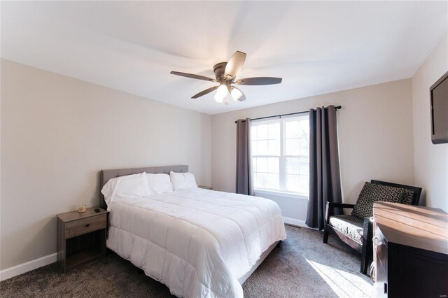 bedroom with a ceiling fan, dark carpet, and baseboards