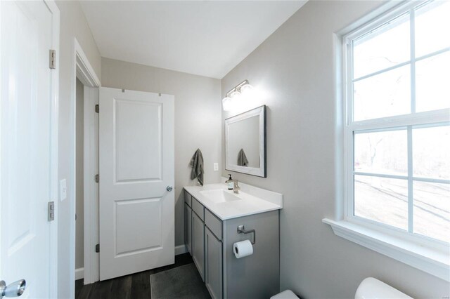 bathroom featuring plenty of natural light, vanity, and toilet