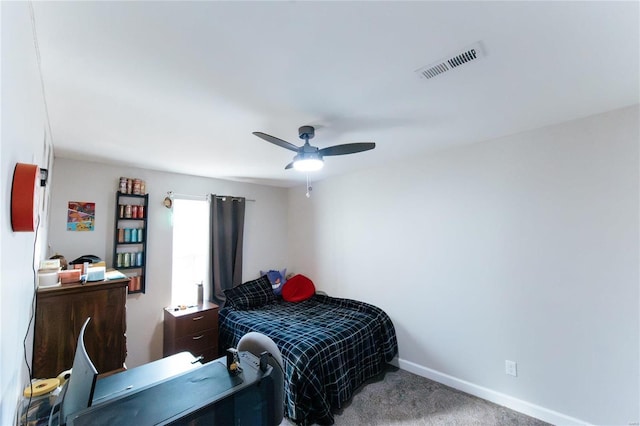 carpeted bedroom with a ceiling fan, visible vents, and baseboards