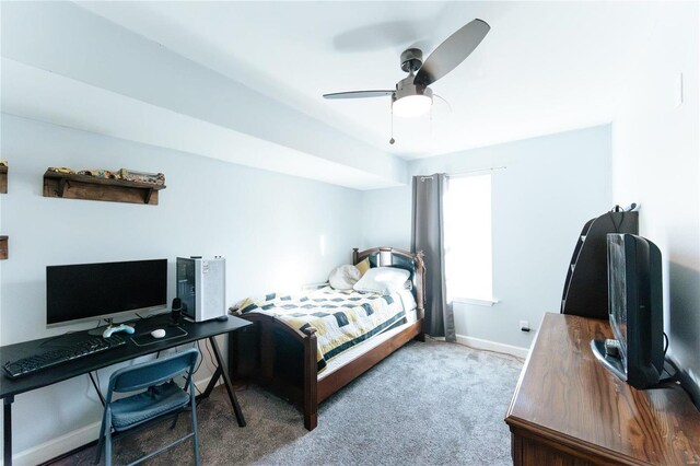 carpeted bedroom with ceiling fan and baseboards