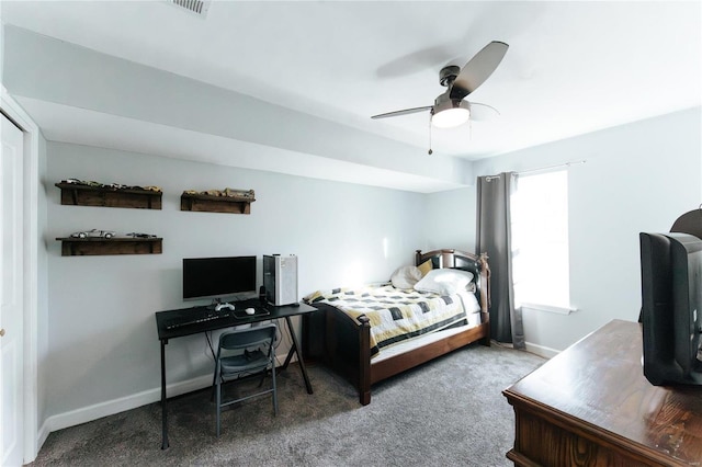 carpeted bedroom featuring ceiling fan, visible vents, and baseboards