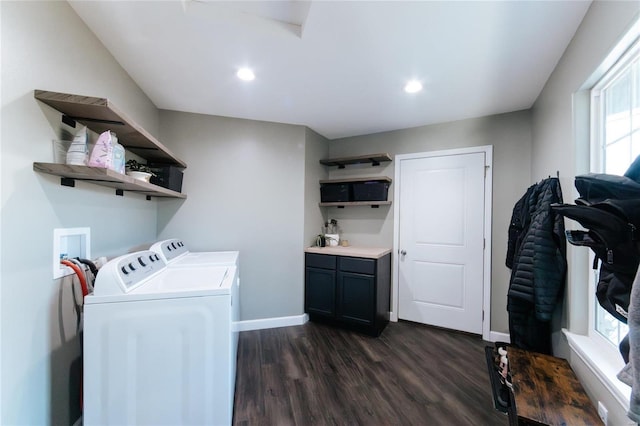 clothes washing area featuring cabinet space, baseboards, dark wood-style flooring, and washer and dryer