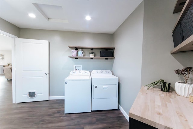 laundry area featuring washer and clothes dryer, recessed lighting, dark wood-type flooring, laundry area, and baseboards