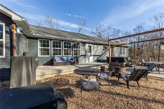 back of house with a fire pit and a patio area