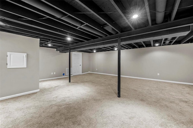 finished basement featuring carpet, visible vents, and baseboards