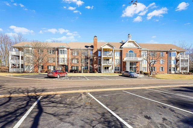 view of property featuring uncovered parking