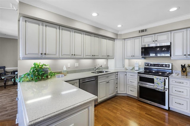 kitchen featuring stainless steel appliances, light countertops, a sink, and visible vents