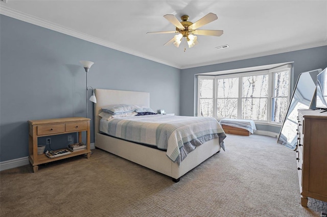 carpeted bedroom with a ceiling fan, visible vents, crown molding, and baseboards