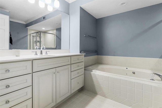 bathroom with a stall shower, visible vents, a garden tub, tile patterned flooring, and vanity