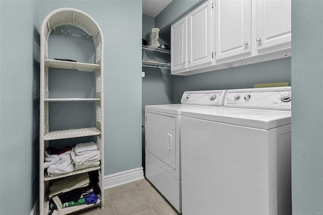 clothes washing area with cabinet space, baseboards, separate washer and dryer, and light tile patterned flooring