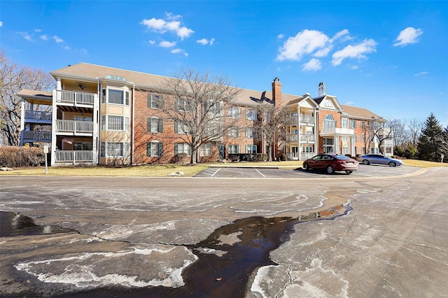 view of property featuring uncovered parking