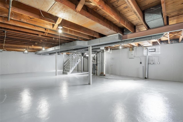 basement with electric panel and stairs