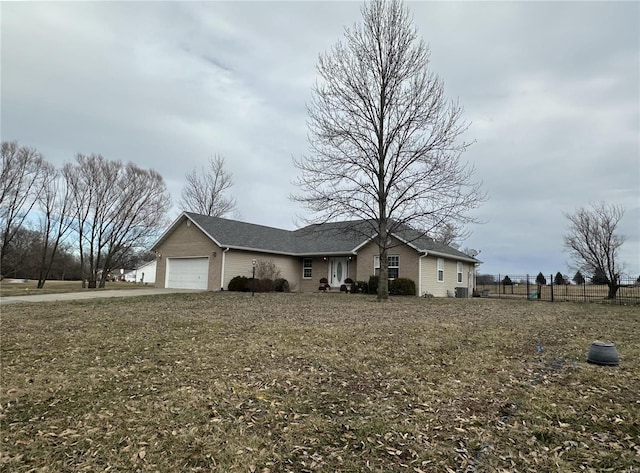 ranch-style house with a garage, a front yard, and fence