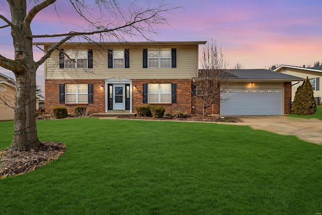 colonial-style house featuring a garage, driveway, a front lawn, and brick siding