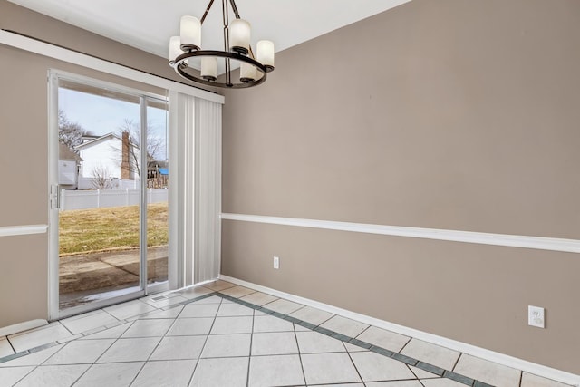 interior space featuring a chandelier, light tile patterned flooring, and baseboards