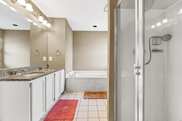 full bathroom featuring a sink, a stall shower, tile patterned flooring, and a bath