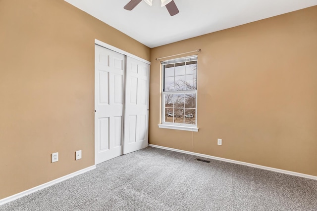 unfurnished bedroom with carpet floors, visible vents, and baseboards