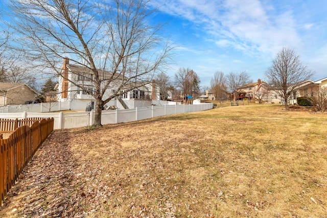 view of yard featuring a residential view and fence