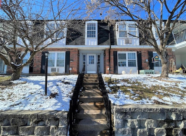 view of property with entry steps and brick siding