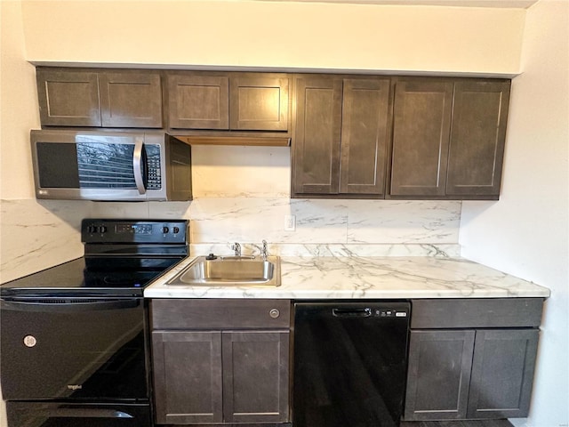 kitchen with light stone countertops, a sink, black appliances, and dark brown cabinets