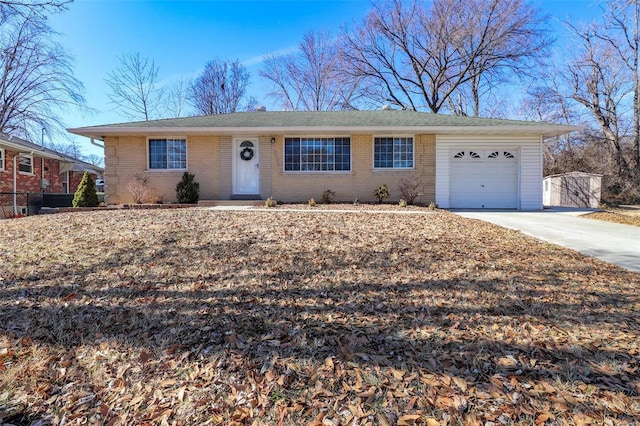 ranch-style home featuring a garage, concrete driveway, and brick siding