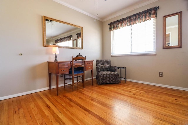 living area featuring baseboards, ornamental molding, and light wood-style floors