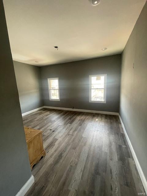 spare room with wood finished floors and baseboards