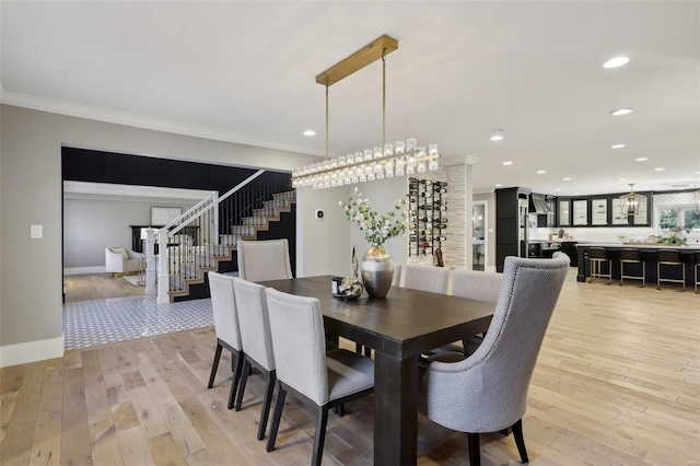 dining space featuring recessed lighting, stairway, light wood-style flooring, and ornamental molding