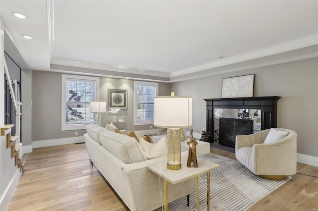 living room with light wood finished floors, recessed lighting, baseboards, and a premium fireplace