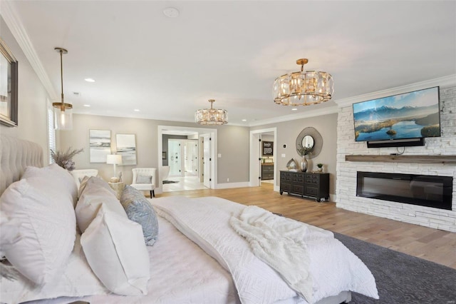 bedroom with crown molding, a fireplace, and a chandelier