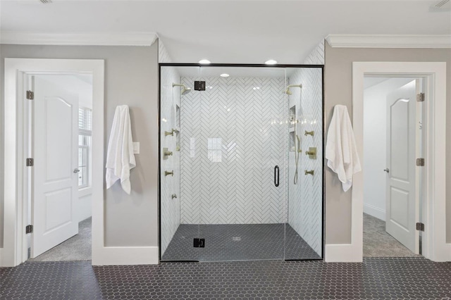 bathroom featuring a stall shower, baseboards, and ornamental molding