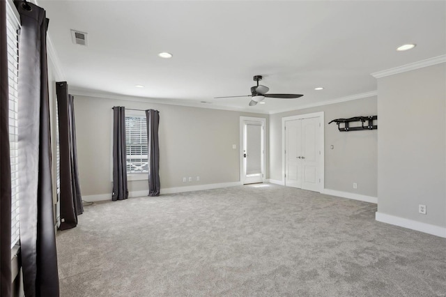 carpeted spare room with visible vents, recessed lighting, baseboards, and ornamental molding