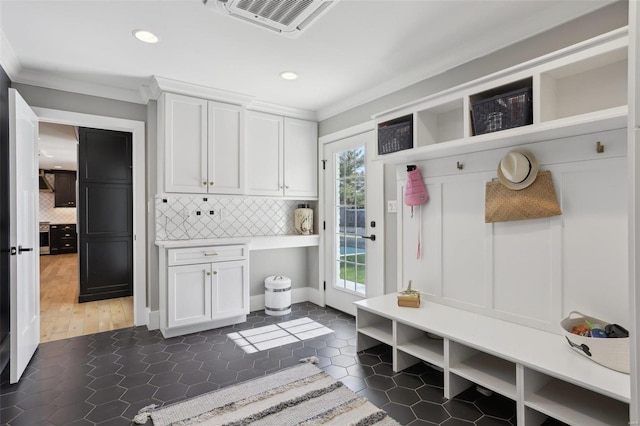 mudroom featuring dark tile patterned flooring, recessed lighting, visible vents, and ornamental molding