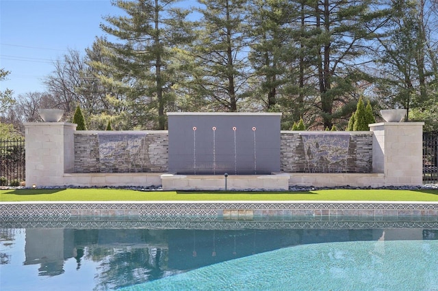 view of swimming pool with a lawn