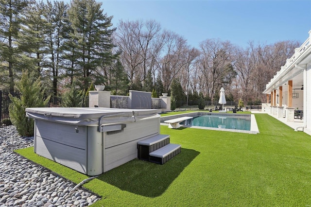 view of yard with a patio area, a fenced in pool, a hot tub, and fence