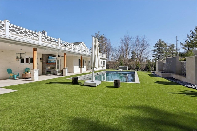 view of pool with a patio, a ceiling fan, a fenced in pool, a yard, and a fenced backyard