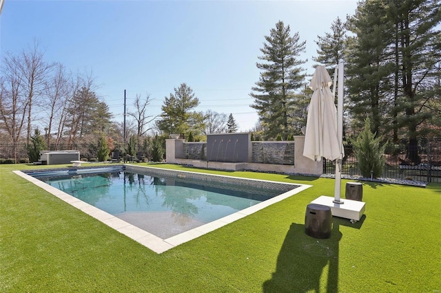 view of swimming pool with a fenced in pool, fence, a lawn, and a hot tub