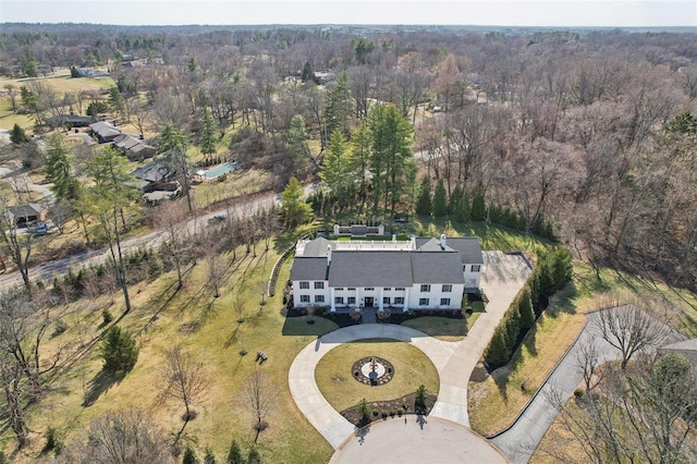 drone / aerial view with a wooded view