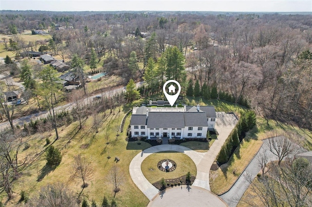 bird's eye view with a wooded view