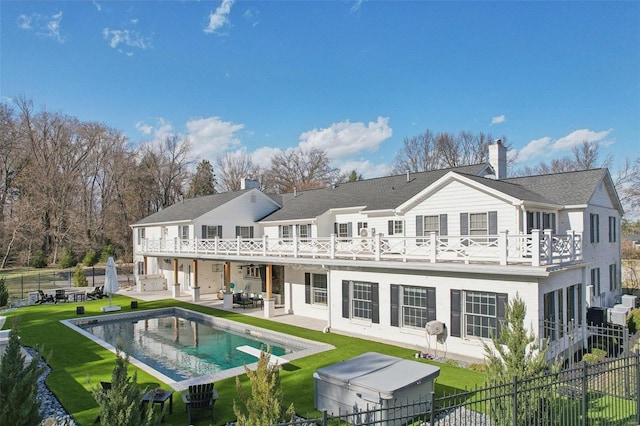 back of house with a yard, a patio, a fenced backyard, and a chimney