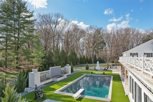 view of swimming pool with a fenced in pool, a yard, a fenced backyard, a diving board, and a patio area