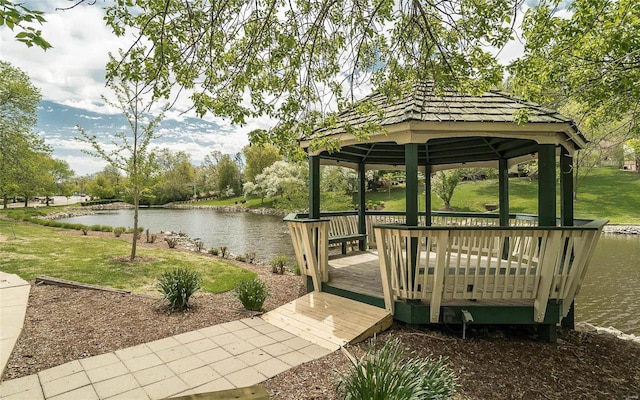 view of property's community with a water view, a yard, and a gazebo