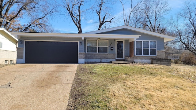 view of front of house featuring a garage, a front lawn, concrete driveway, and brick siding