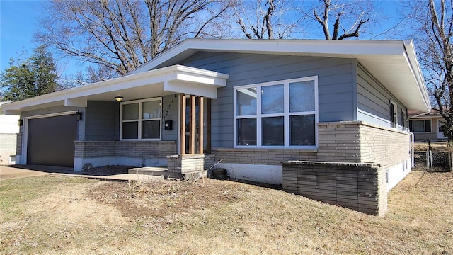 view of front of house featuring a garage, driveway, and brick siding