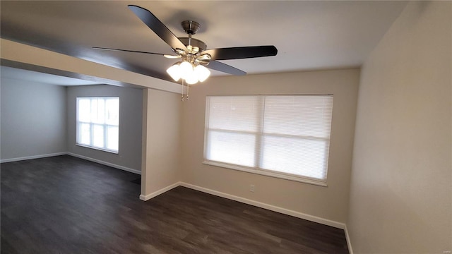 empty room featuring ceiling fan, dark wood-type flooring, and baseboards