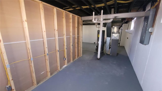 unfinished below grade area featuring water heater and heating unit